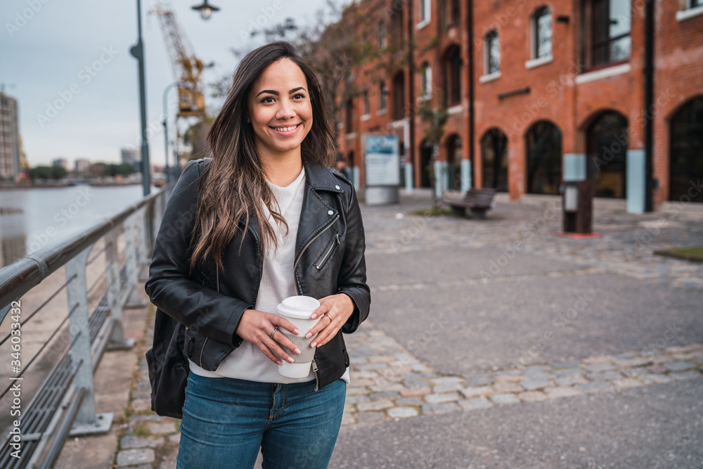 Fototapeta premium Young woman holding a cup of coffee.