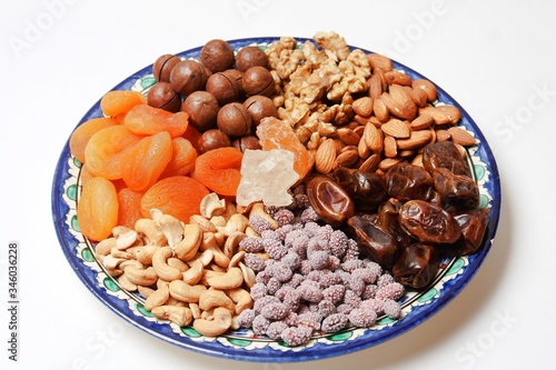 Plate With Dried Fruits And Nuts On Plate Isolated On White Background. Side View. Ramadan Concept.