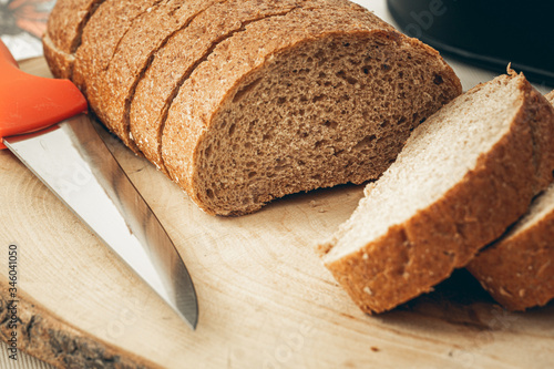 sliced whole wheat bread with knife on wooden drops