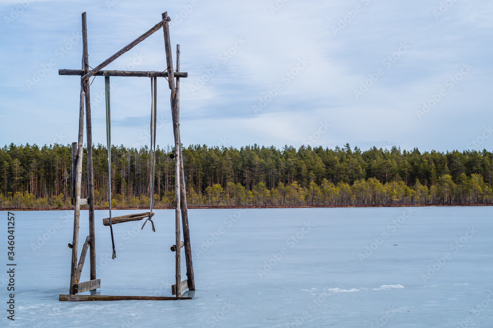 Swing stand on a frozen lake. solitude concept. nature landscape Swing stand on a frozen lake. solitude concept. nature landscape
