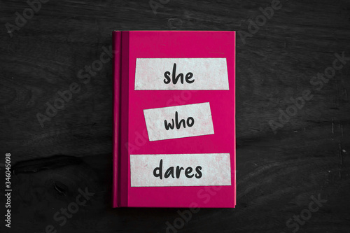 A pink book with a simple three worded message written on the front. 