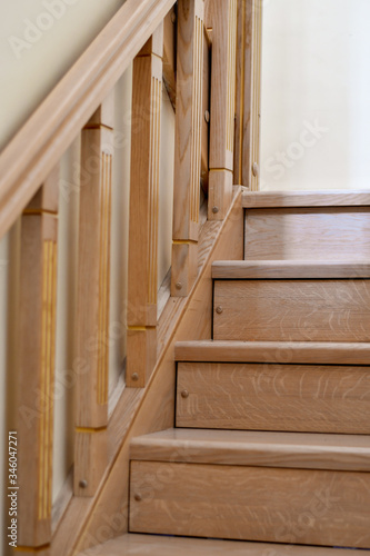 Detail of the wooden interior staircase in the house. Sellective focus. Low DOF photo
