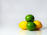 stacked limes and lemons on white background