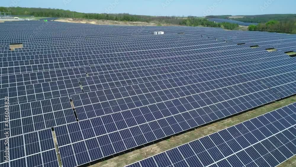 Aerial view of solar power station field at sunny day. Aerial Top View of Solar Farm. Renewable energy technology. Wide shot Aerial view of solar power station field at sunny day. Aerial Top View of Solar Farm. Renewable energy technology. Wide shot