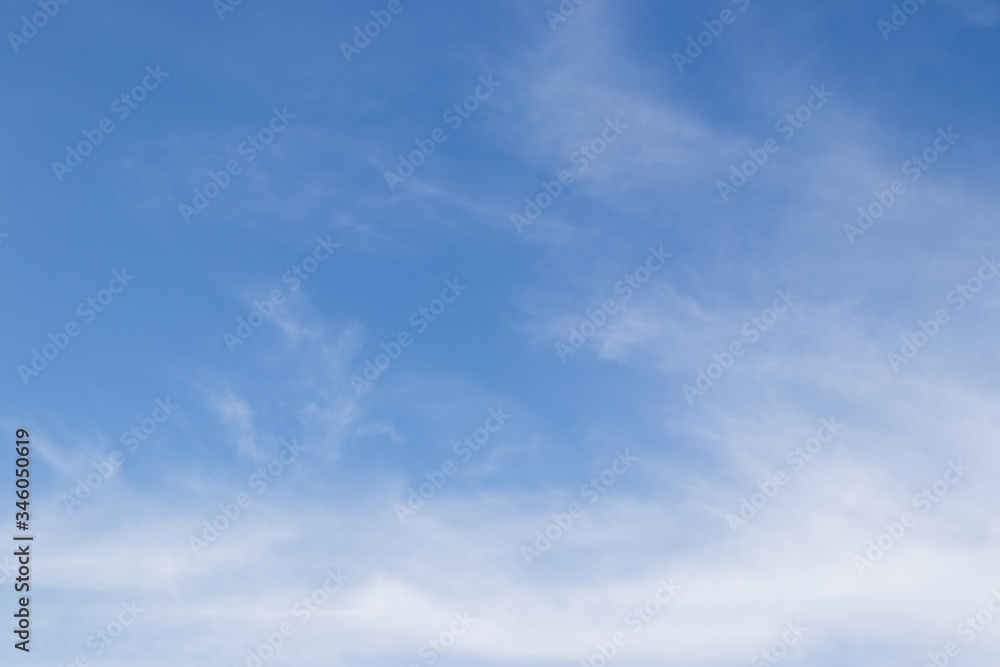 Clear blue sky with white cloud background