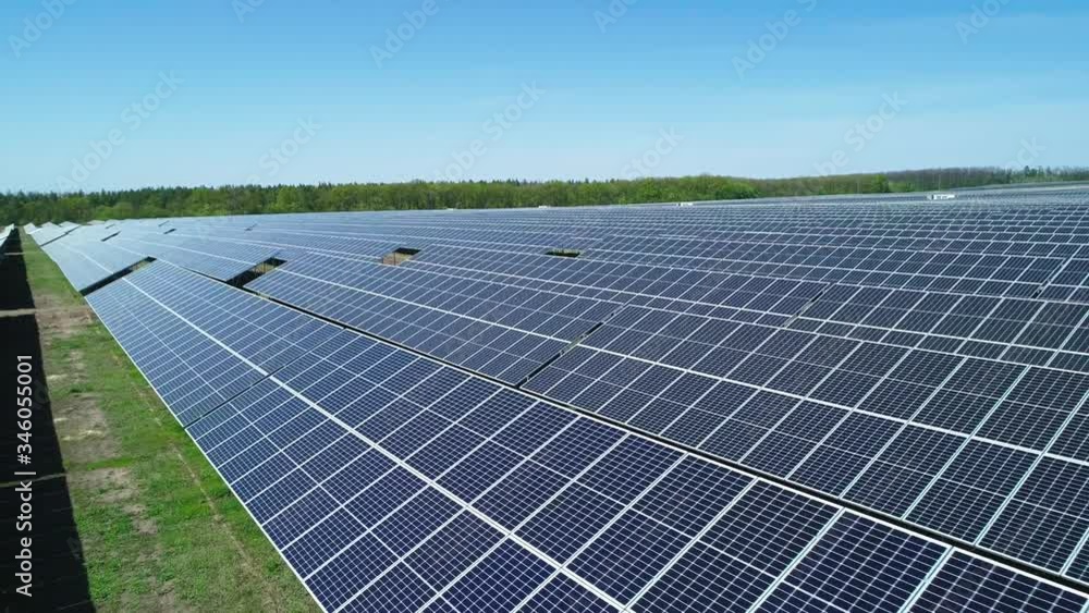 Aerial view of solar power station field at sunny day. Aerial Top View of Solar Farm. Renewable energy technology. Wide shot Aerial view of solar power station field at sunny day. Aerial Top View of Solar Farm. Renewable energy technology. Wide shot