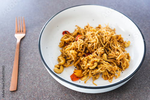 plant-based food, vegan ginger noodles with pickeld capsicum and roasted cashew photo