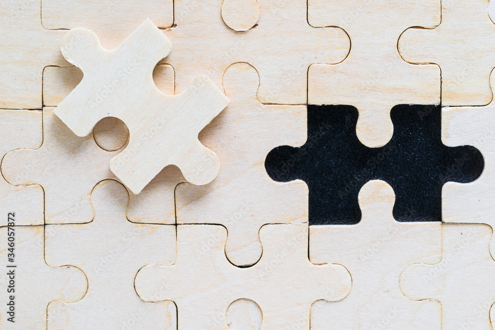 Close up wooden jigsaw puzzle pieces on black background Close up wooden jigsaw puzzle pieces on black background