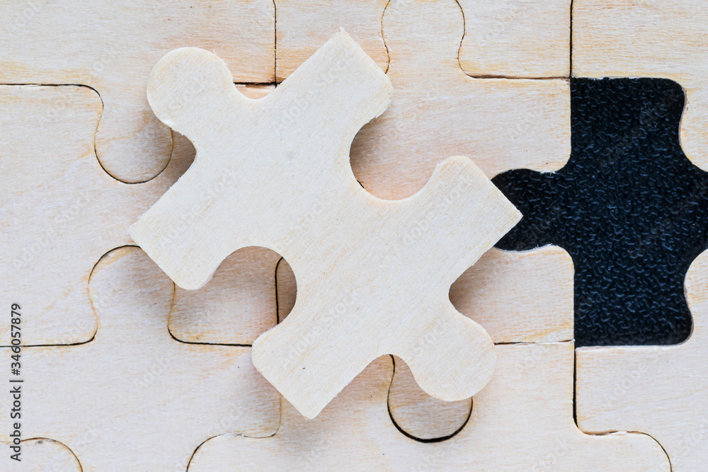 Close up wooden jigsaw puzzle pieces on black background Close up wooden jigsaw puzzle pieces on black background
