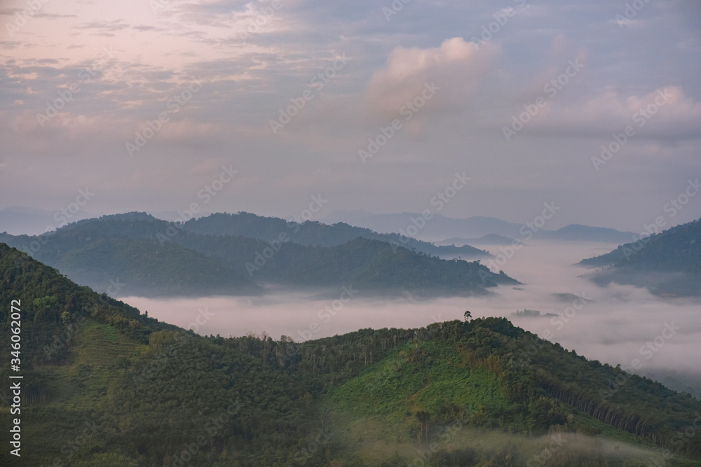 Scenery of mountains under mist in the morning in Thailand.