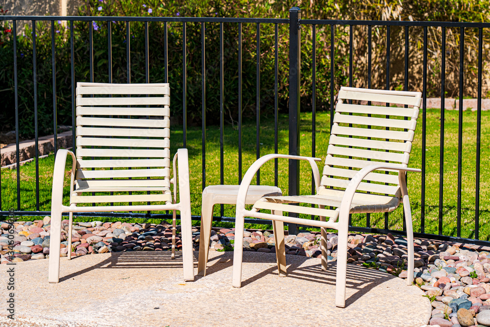Two chairs by the pool