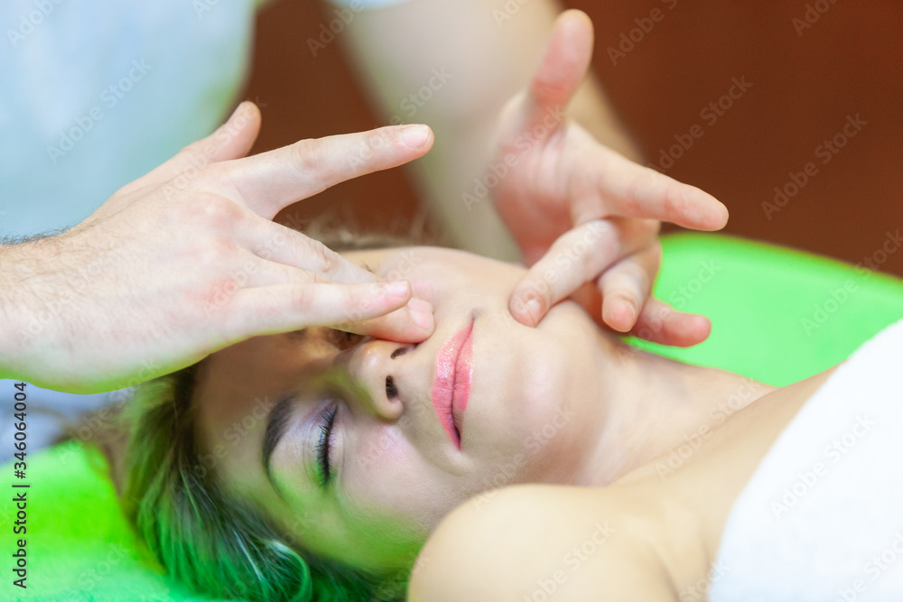 Fototapeta premium Photo of a part of face of calm female during luxurious procedure of massage