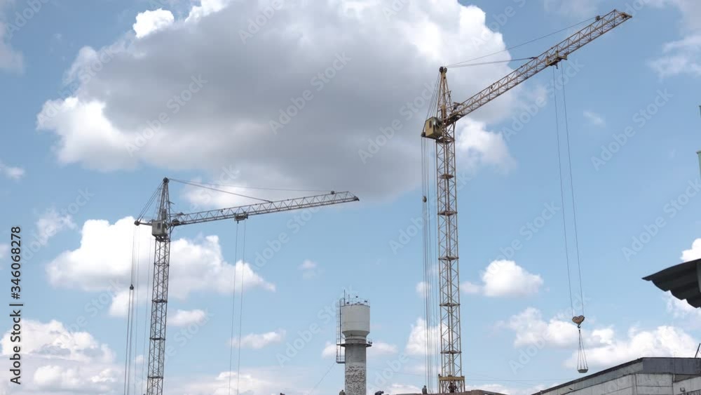 Construction crane on a building background. Territory of construction houses Construction crane on a building background. Territory of construction houses