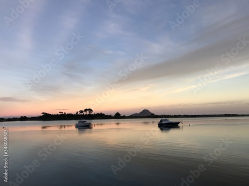 boats by the sea at sunset