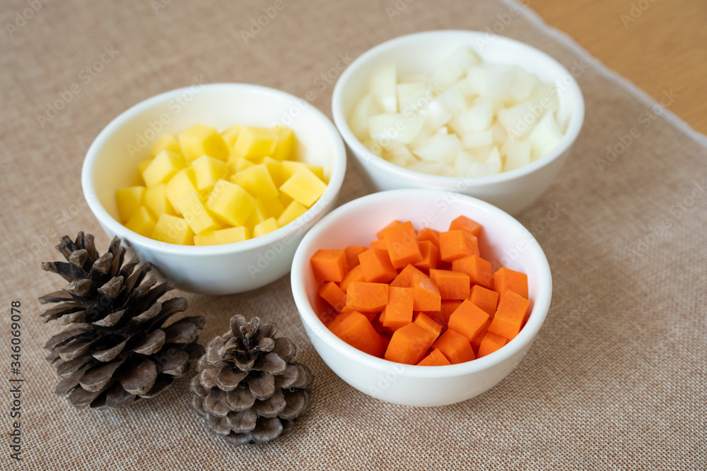 Group of sliced raw food material included; boiled carrot, boiled potato and boiled onion cut in cube shape. Mixed vegetable in a pot, prepare for cooking. Group of sliced raw food material included; boiled carrot, boiled potato and boiled onion cut in cube shape. Mixed vegetable in a pot, prepare for cooking.