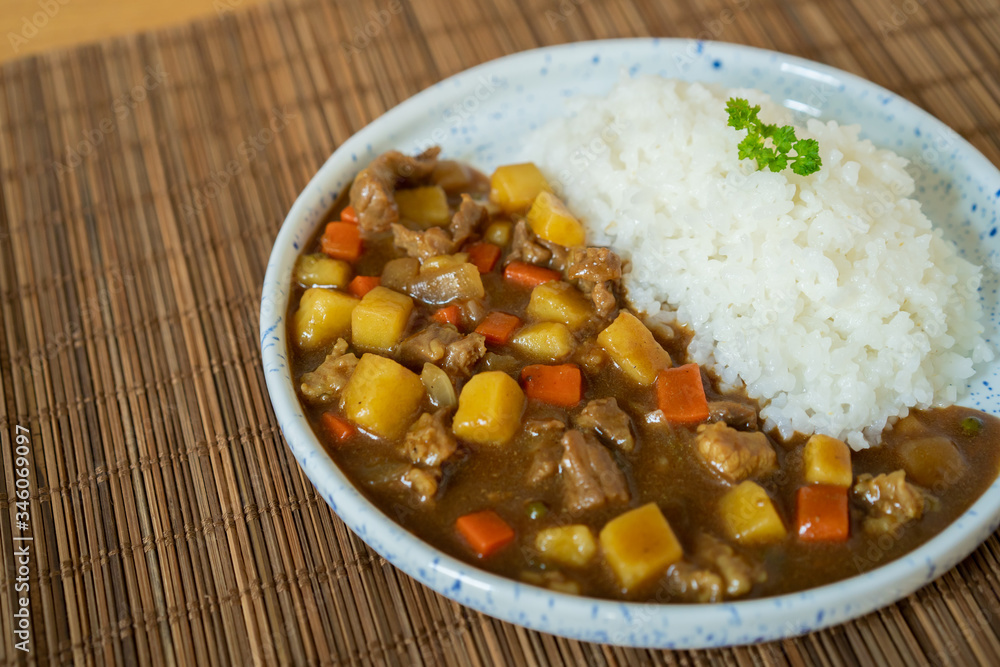 Japanese beef curry served with Japanese Rice close up. Traditional popular food of Japan. Japanese beef curry served with Japanese Rice close up. Traditional popular food of Japan.