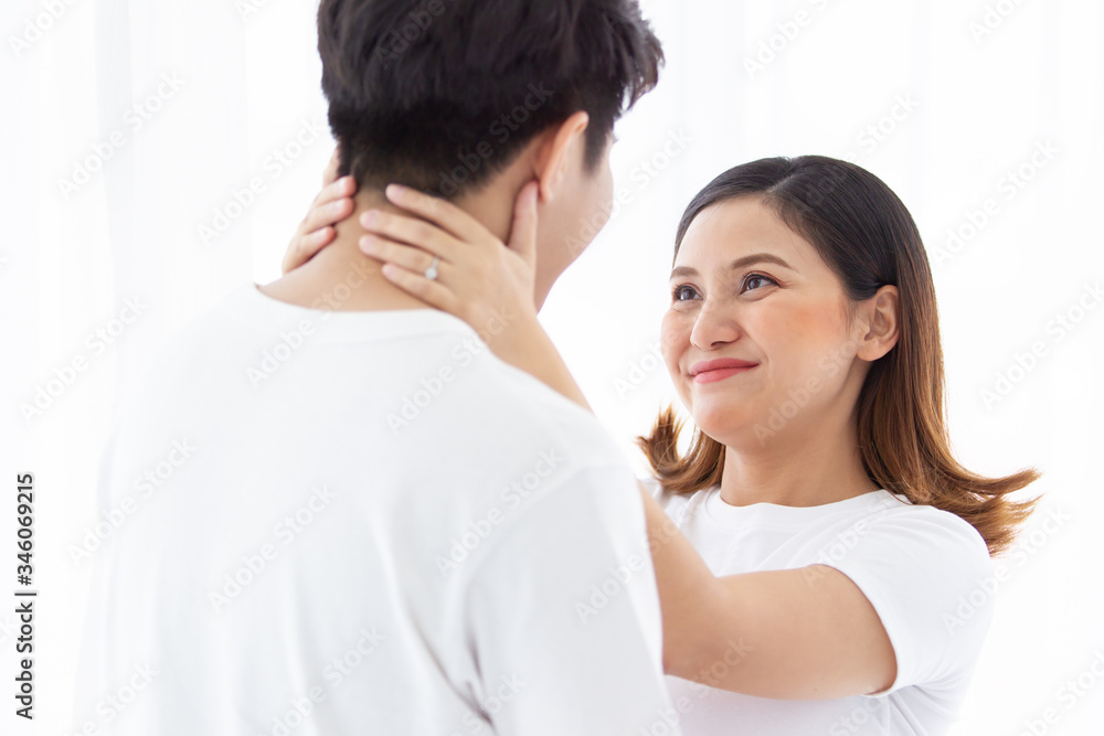 Asian lovely husband and wife portrait, his wife is in pregnancy. Husband tenderly hug and kiss his wife on the bed with care. Husband embracing his pregnant wife and making their hands in heart shape Asian lovely husband and wife portrait, his wife is in pregnancy. Husband tenderly hug and kiss his wife on the bed with care. Husband embracing his pregnant wife and making their hands in heart shape