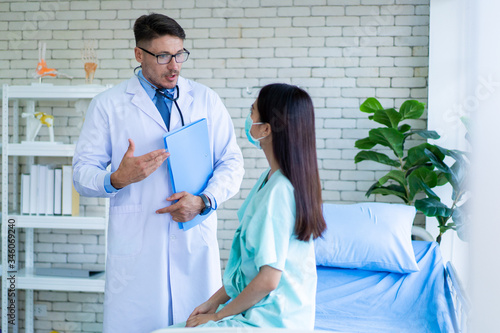 Asian woman got a sickness from covid-19 virus having a consultation with professional doctor in hospital. Doctor explaining about healthcare and sickness avoidance. Medical consultant service.