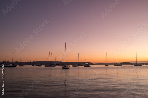 serene scene with yachts on the water at dawn © Tim
