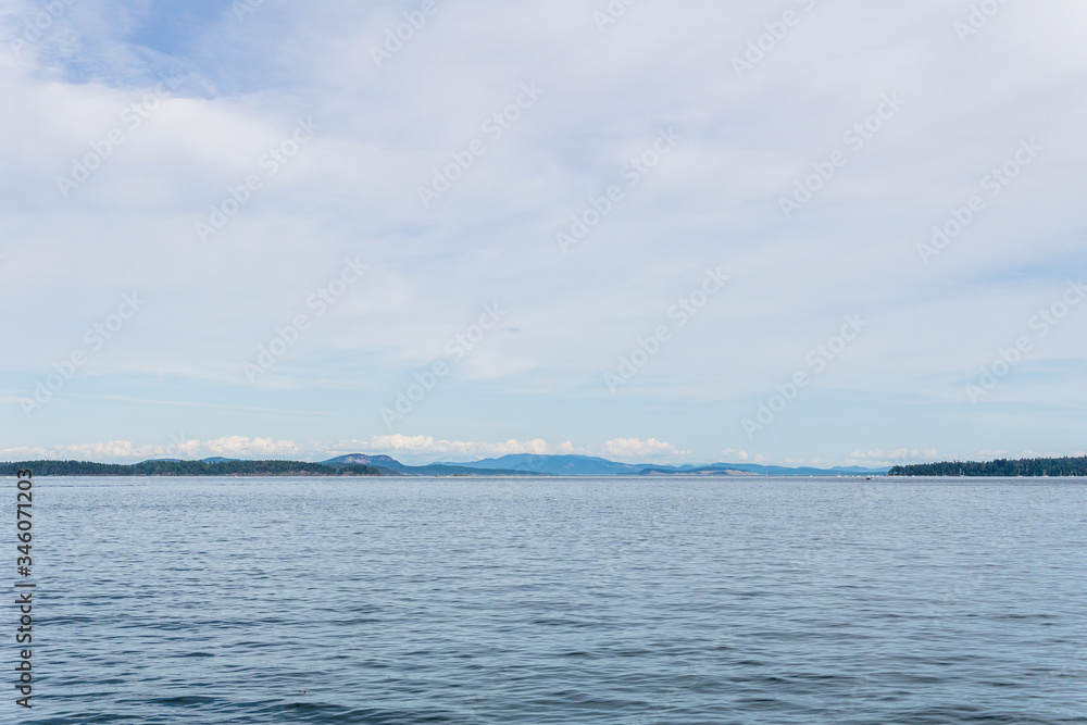 Haro strait view from Vancouver island with cloudy sky British Columbia Canada.