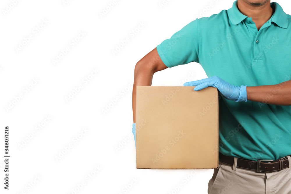 Delivery man wearing green shirts holding cardboard boxes on his side in medical rubber gloves. Online shopping and Express delivery concept. Delivery man wearing green shirts holding cardboard boxes on his side in medical rubber gloves. Online shopping and Express delivery concept.