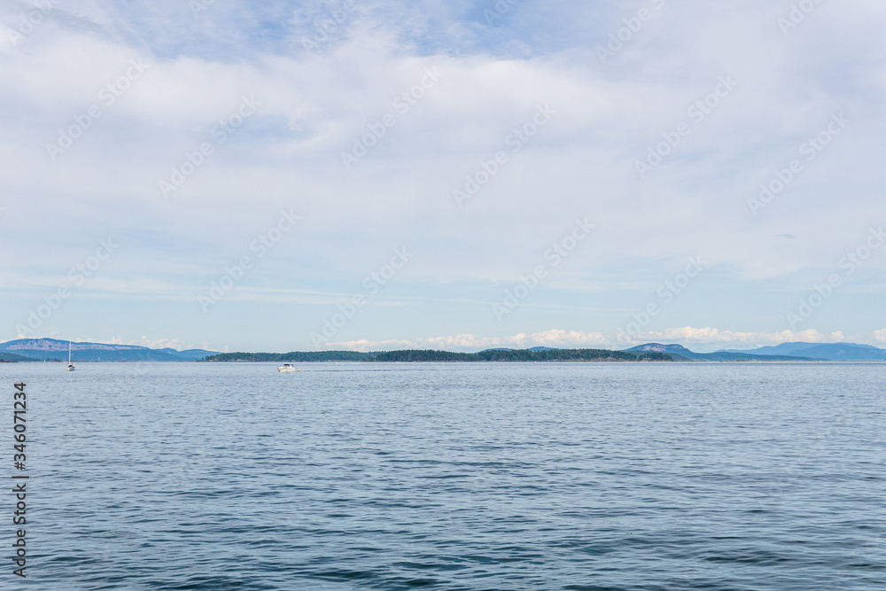 Haro strait view from Vancouver island with cloudy sky British Columbia Canada.