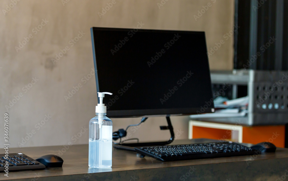 Fototapeta premium Hand sanitizer alcohol gel pump bottle on the table in office, Health care and COVID-19 Coronavirus concept