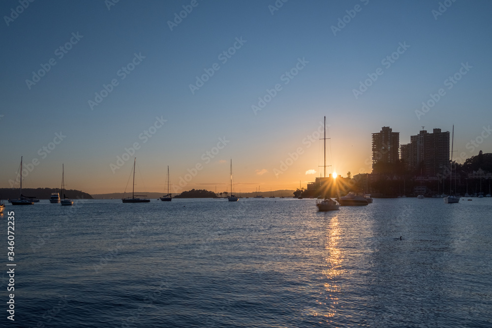 yachts on the water at sunrise