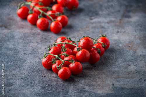Fresh cherry tomatoes on dark background.