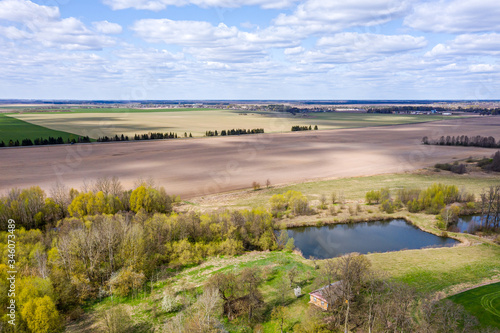 Fototapeta Naklejka Na Ścianę i Meble -  plowed fields in countryside. rural landscape on a bright sunny day. aerial view