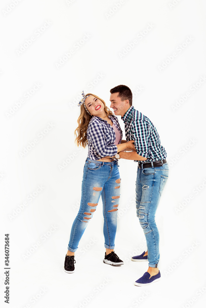 A guy tickles a girl, very beautiful young people have fun, dressed in plaid shirts A guy tickles a girl, very beautiful young people have fun, dressed in plaid shirts