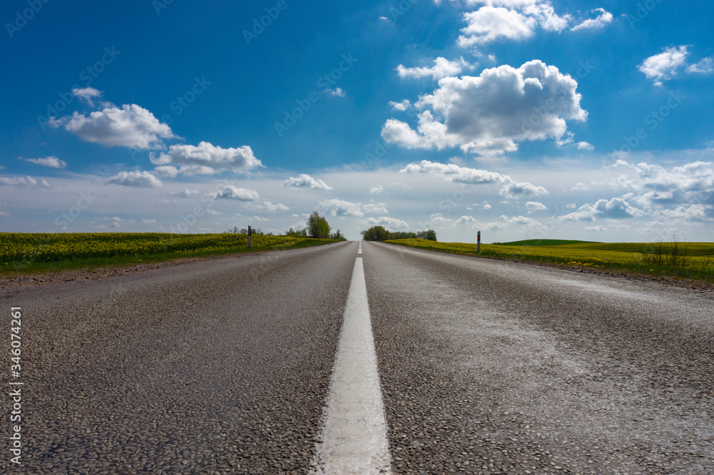 Low angle view of a tarred road receding Low angle view of a tarred road receding