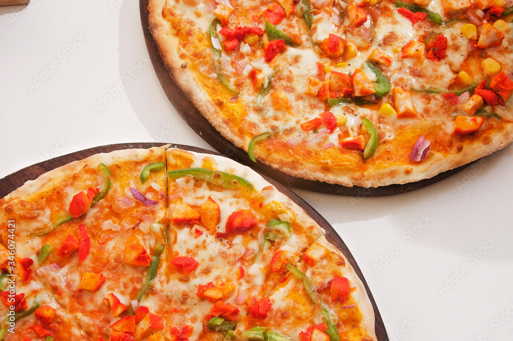 A chicken pizza served on a table ready to eat A chicken pizza served on a table ready to eat