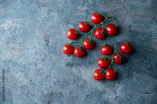 Fresh cherry tomatoes on dark background.