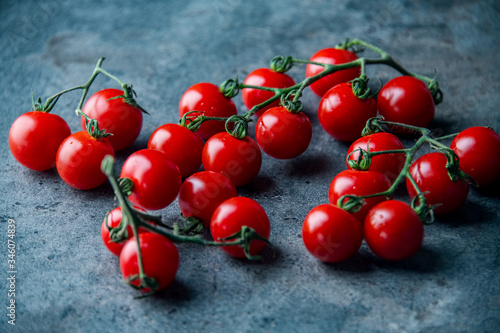 Fresh cherry tomatoes on dark background.