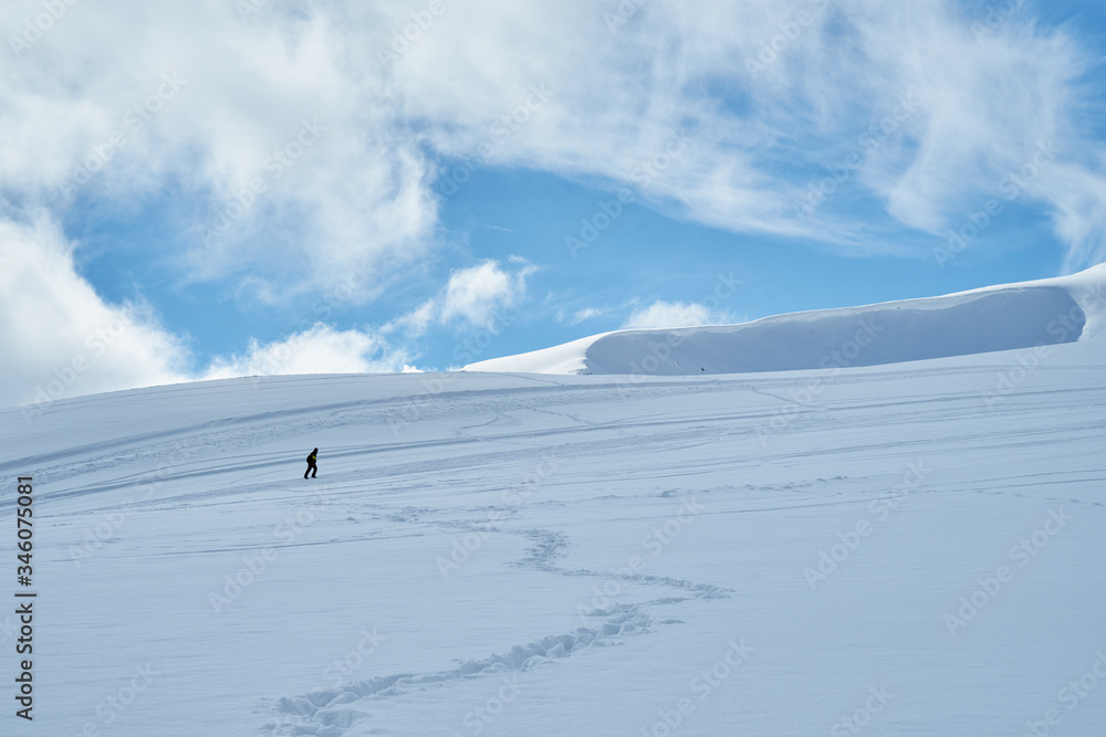 Image of a snow covered mountain plateau. Tourists walk and take pictures on a mountain plateau. Image of a snow covered mountain plateau. Tourists walk and take pictures on a mountain plateau.