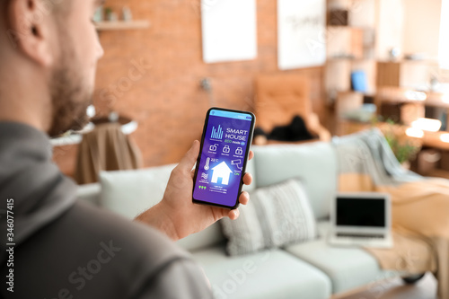 Man using application of smart home automation photo