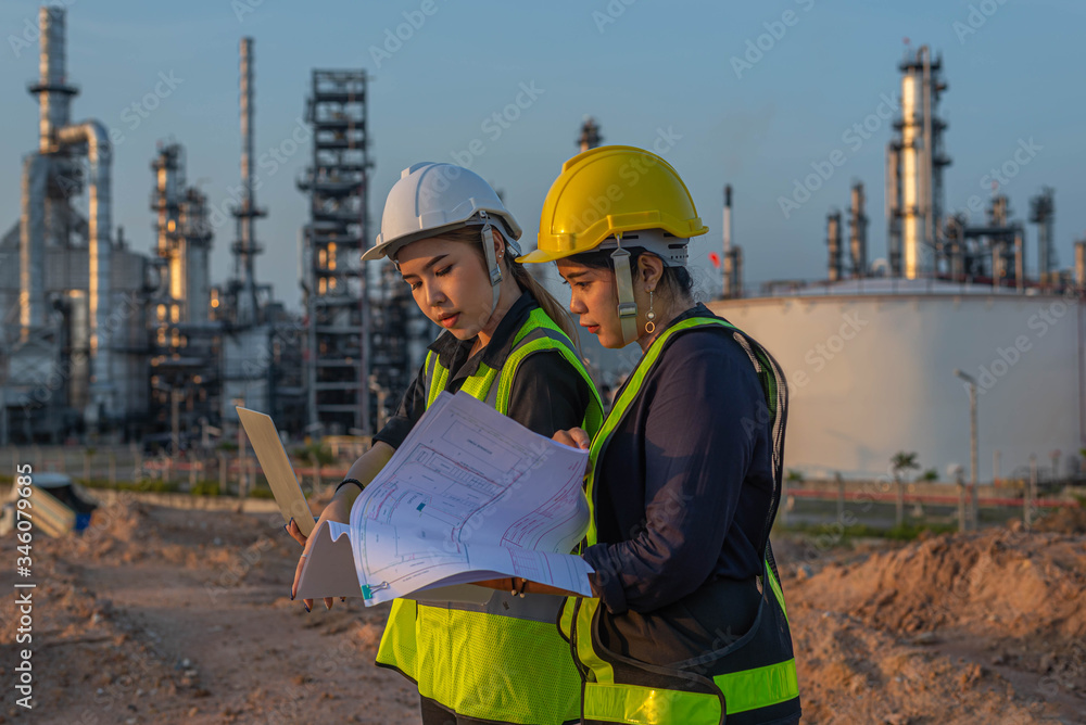 White woman engineer, logistics and transportation business of gas and oil with background of oil and gas refinery, import, export and transportation in the industry White woman engineer, logistics and transportation business of gas and oil with background of oil and gas refinery, import, export and transportation in the industry
