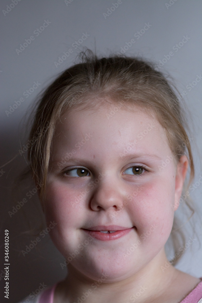 The girl smiles, expressing joy on her baby face The girl smiles, expressing joy on her baby face