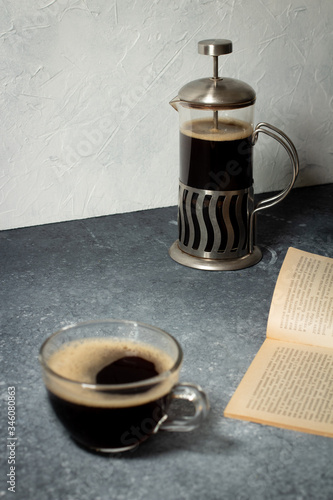 coffee in a transparent mug on a gray background