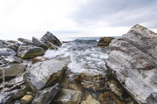 Waves among the stones on the sea coast