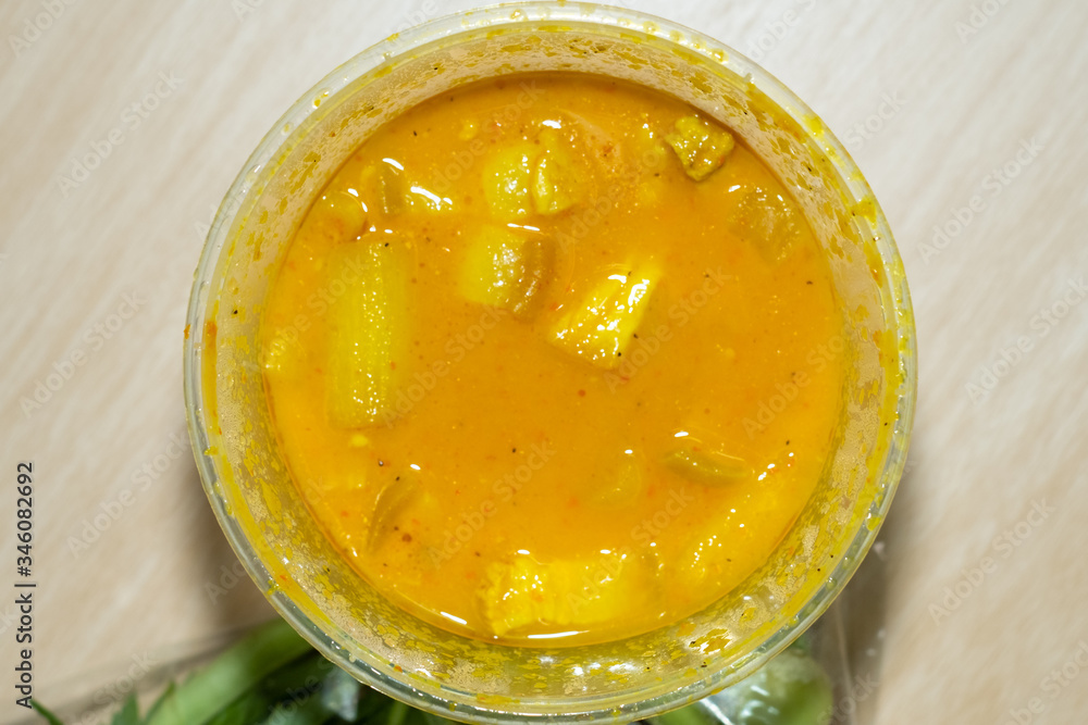 sour curry with pork in plastic cup sour curry with pork in plastic cup