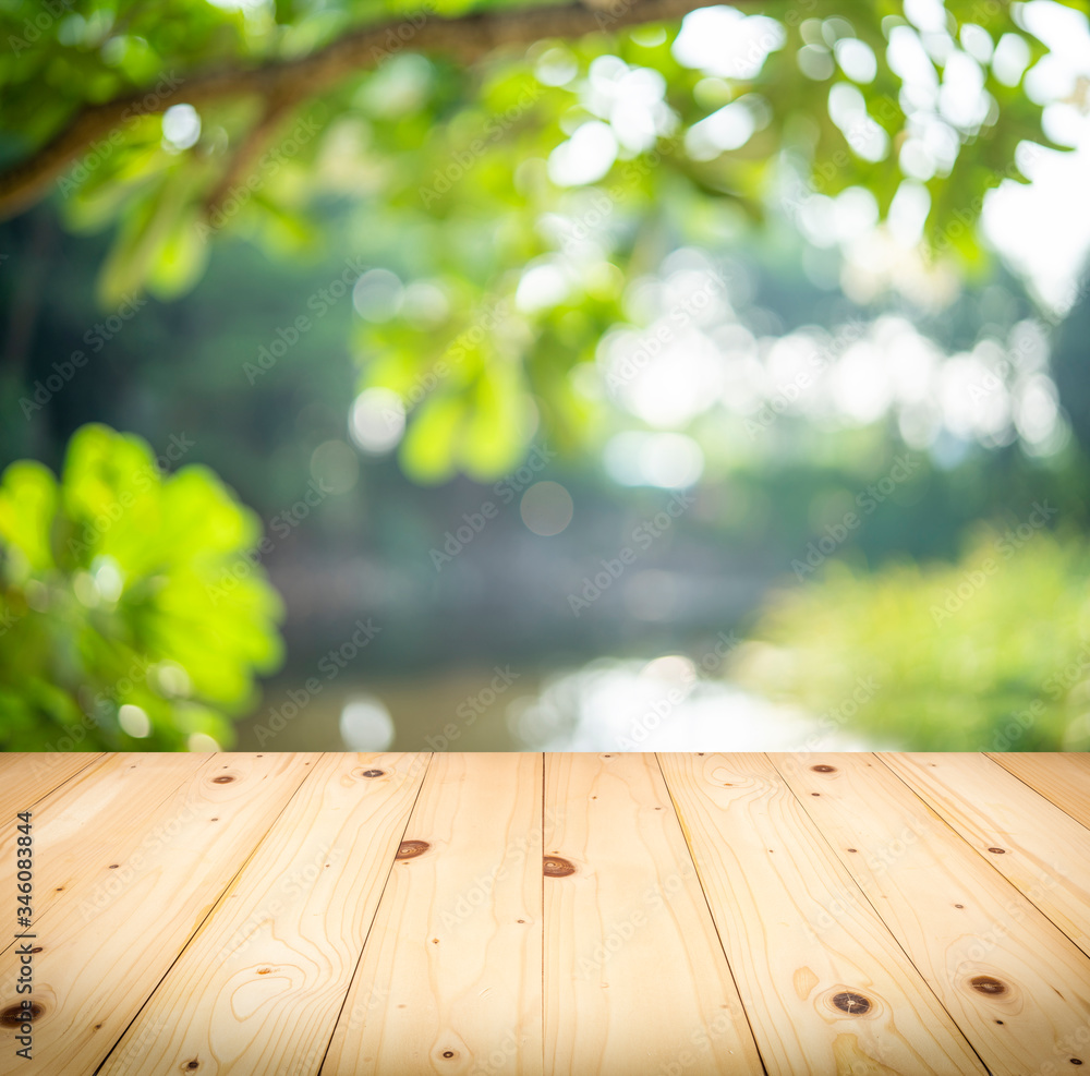Wood balcony over blur nature view of green leaf on blurred greenery background in garden Wood balcony over blur nature view of green leaf on blurred greenery background in garden