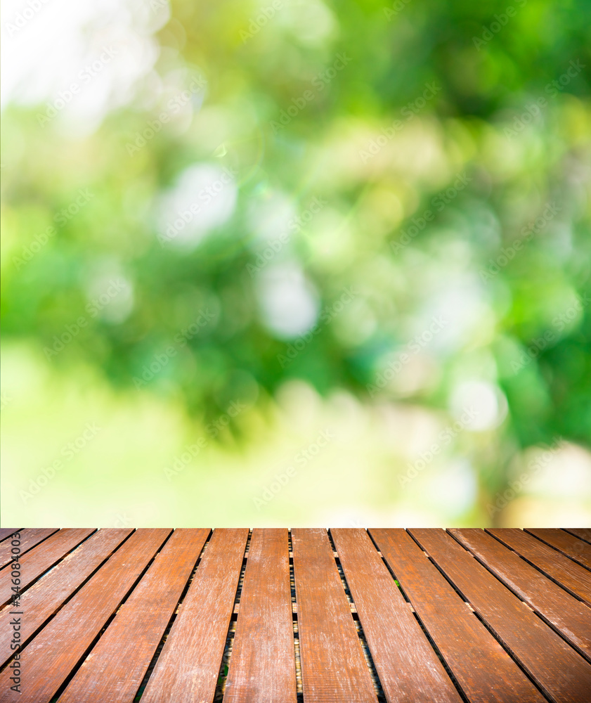 Wood balcony over blur nature view of green leaf on blurred greenery background in garden