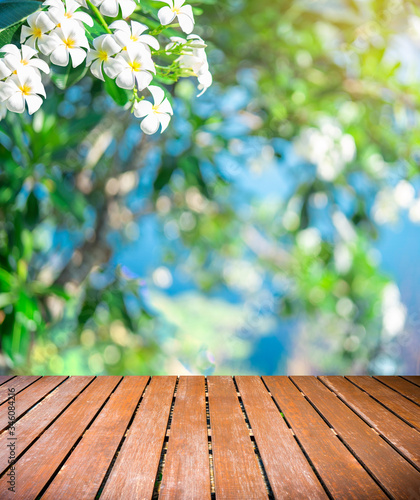 Wood balcony over blur nature view of green leaf on blurred greenery background in garden