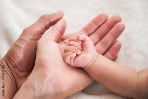 newborn baby feet in mother hands