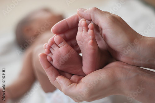 mother holding her baby hand