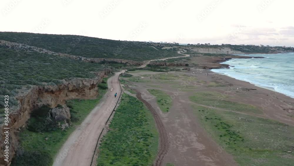 Aerial drone video of group of runners running on the beach at the morning. Pegeia Paphos Cyprus Aerial drone video of group of runners running on the beach at the morning. Pegeia Paphos Cyprus