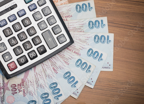 turkish lira banknotes on the table, minimum wage on the calculator screen photo