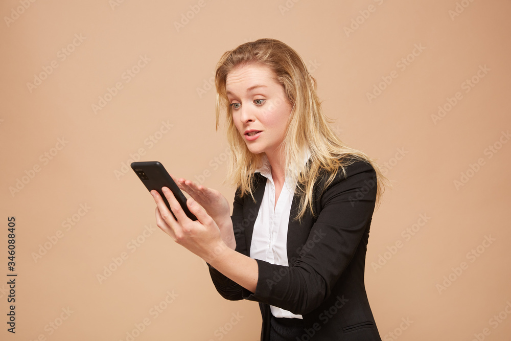 Beautiful, angry businesswoman with a cellphone Beautiful, angry businesswoman with a cellphone